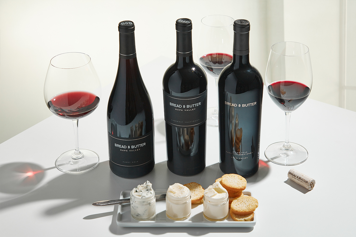 Bread & Butter Limited Production Wines including Napa Valley Pinot Noir, Napa Valley Cabernet Sauvignon, and Atlas Peak Cabernet Sauvignon behind a selection of butters in small jars served with crostini. Pair with Wild Mushroom Butter.
